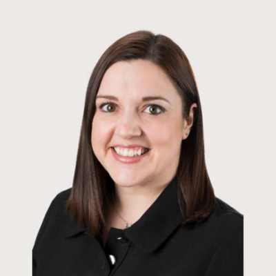 Head and shoulders of Kim McDonald who is smiling and facing forward