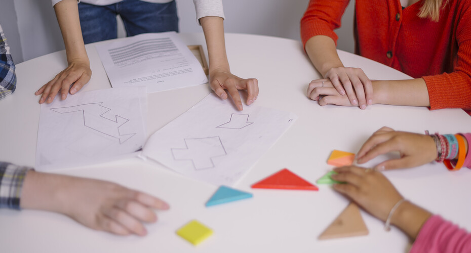 Hands working on shared paper