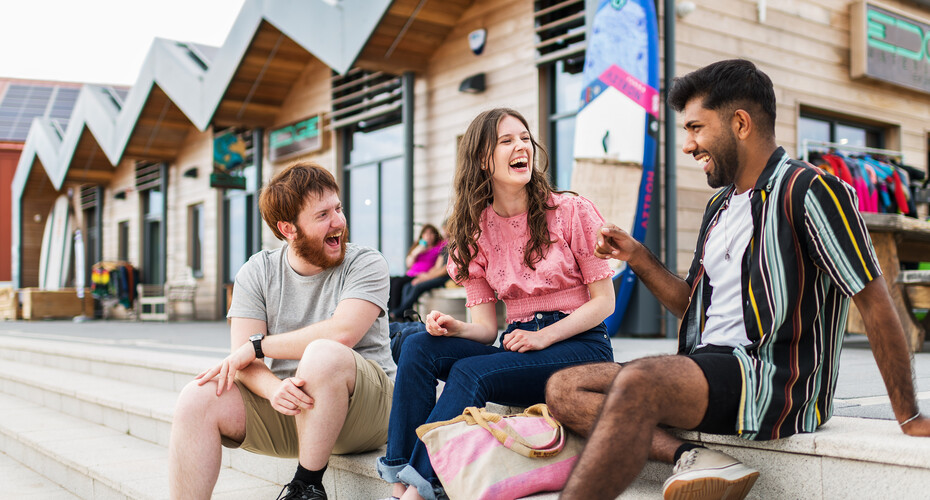 Students by beach huts in Exmouth