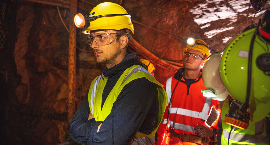 engineering students on location wearing hard hats and PPE