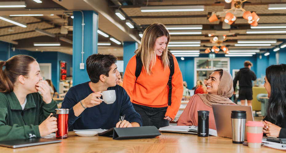 students sat around table socialising