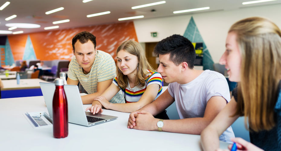 Students gathered around laptop