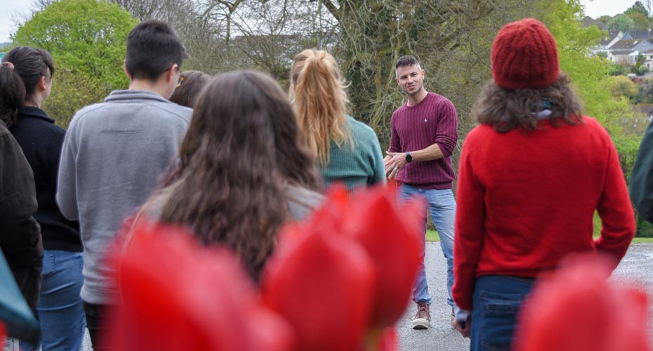 An researcher talking to a group of people from the local community on campus