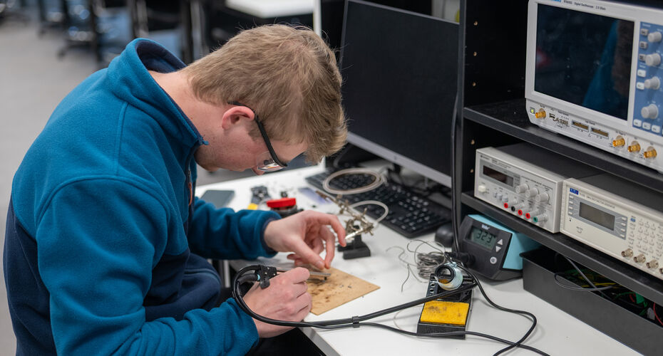 Electrical and Electronic Engineering student working in a lab
