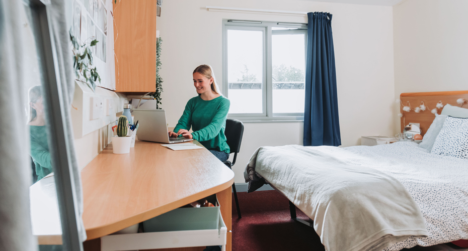 student at desk in bedroom