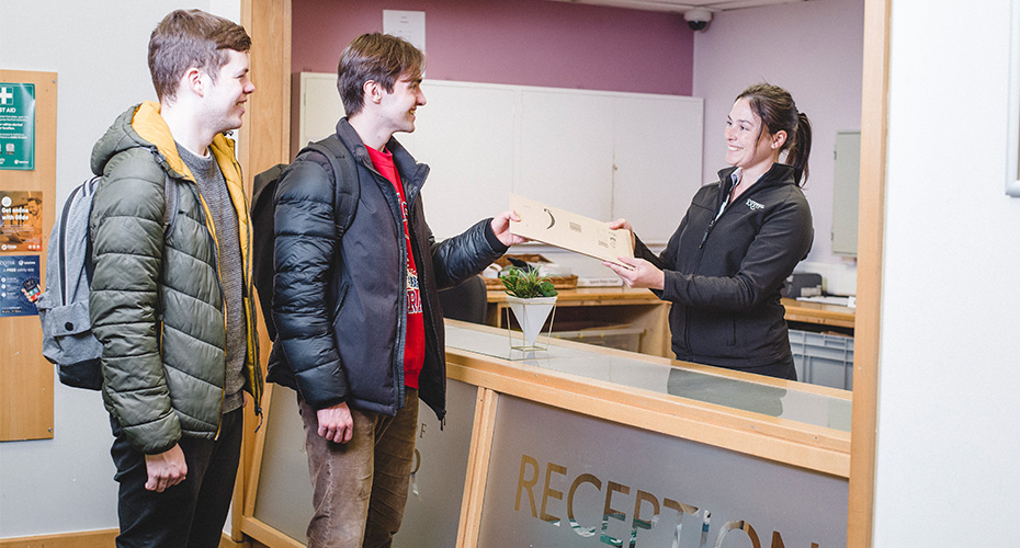 Two people at a Reception desk