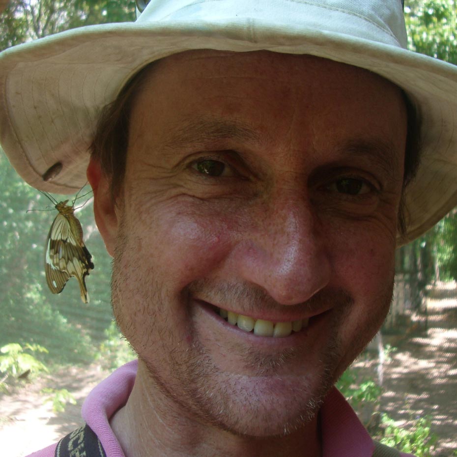 Headshot photo of man wearing sun hat