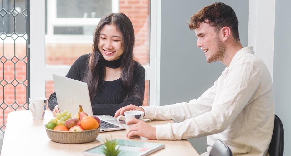 Students looking at a laptop