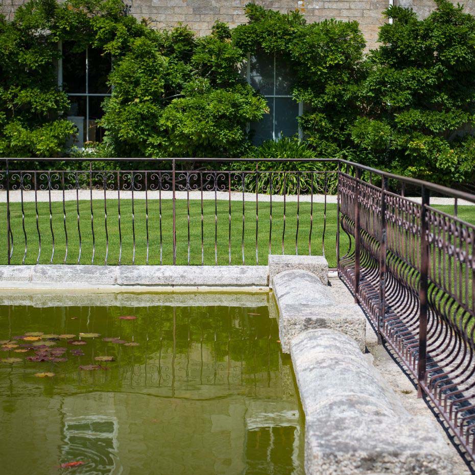 Outdoor swimming pool with metal fence around it