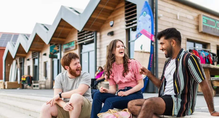 Student sat near some shops on Exmouth sea front