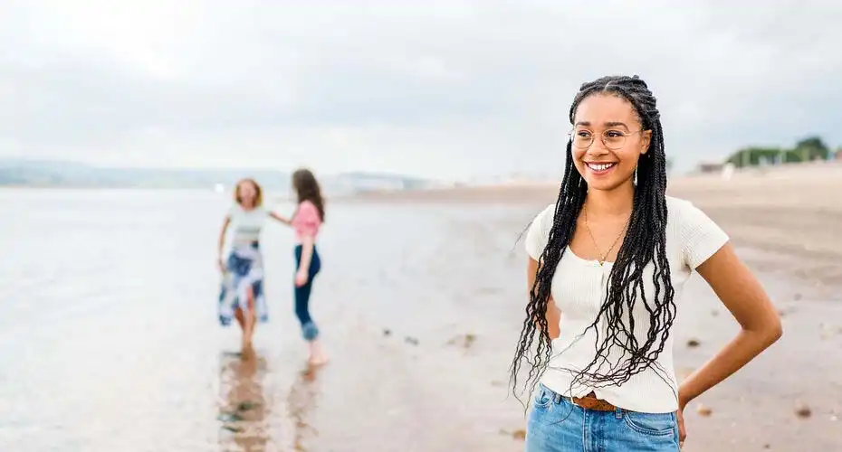 Students paddling in the sea at Exmouth beach