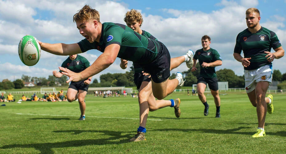 A rugby player dives for the line at training