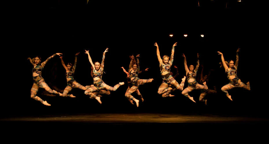 Students dancing on stage in a performance by the Exeter University Dance Society