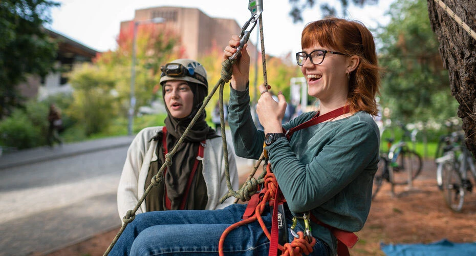 A student wearing a climbing harness