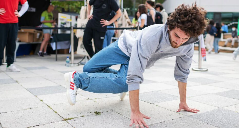 A student breakdancing on the Forum Piazza