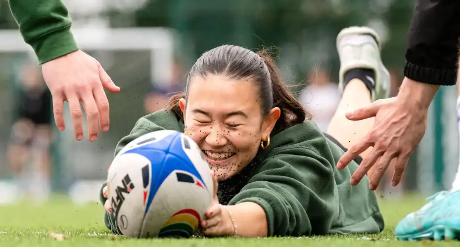 A student scoring a try at a rugby taster event