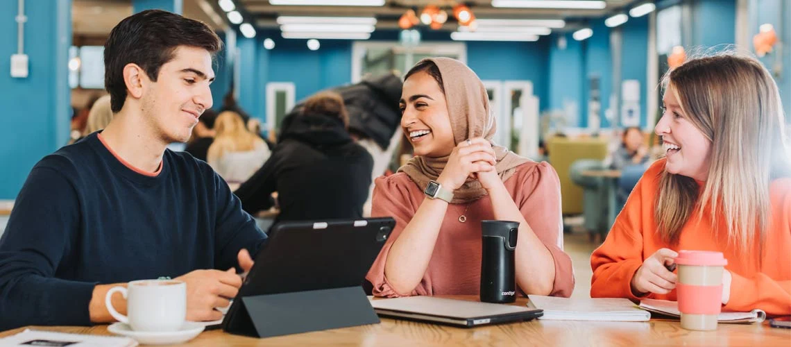 Student working in a cafe on campus