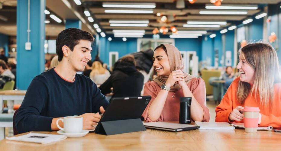 Student working in a cafe on campus