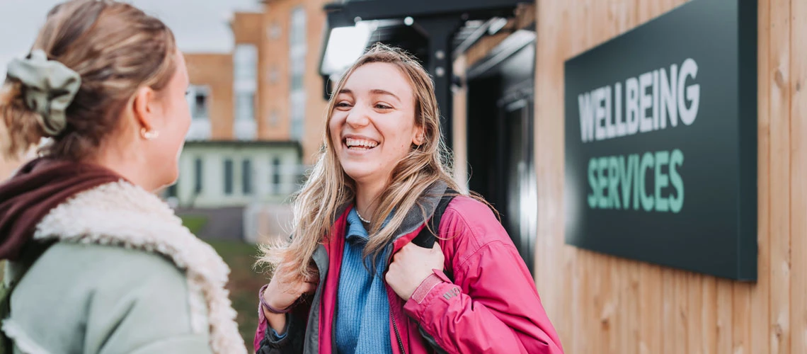 Students talking outside of Wellbeing Serives
