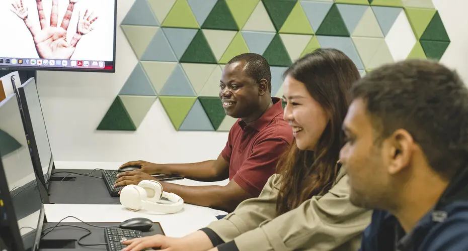 Students working in a computer lab, with an AI generated image of a hand in the background