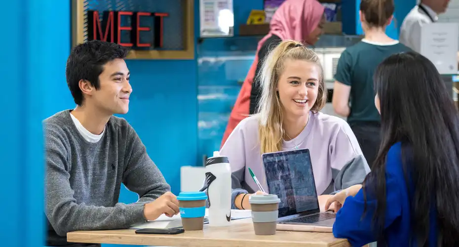 Three students enjoying a relaxed study session together