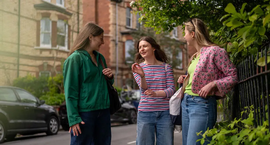 Students stood in the street chatting in a residential area in Exeter