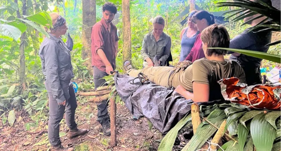 Students on a jungle medicine residential in Costa Rica. One student lying on a stretcher made of leaves and bamboo.