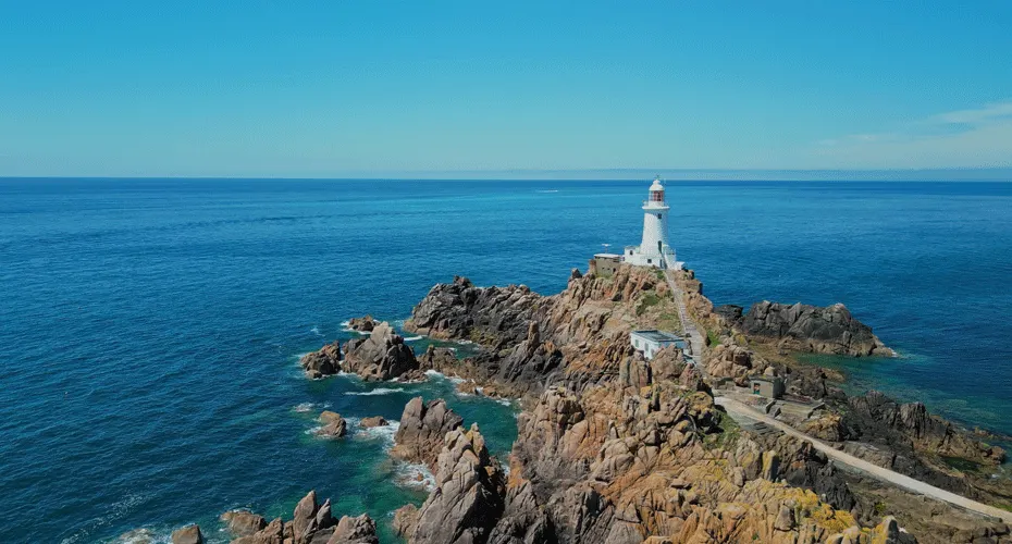 A lighthouse on a rocky peninsular in Jersey