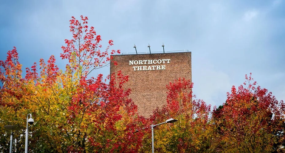 The Northcott Theatre with autumnal trees in front