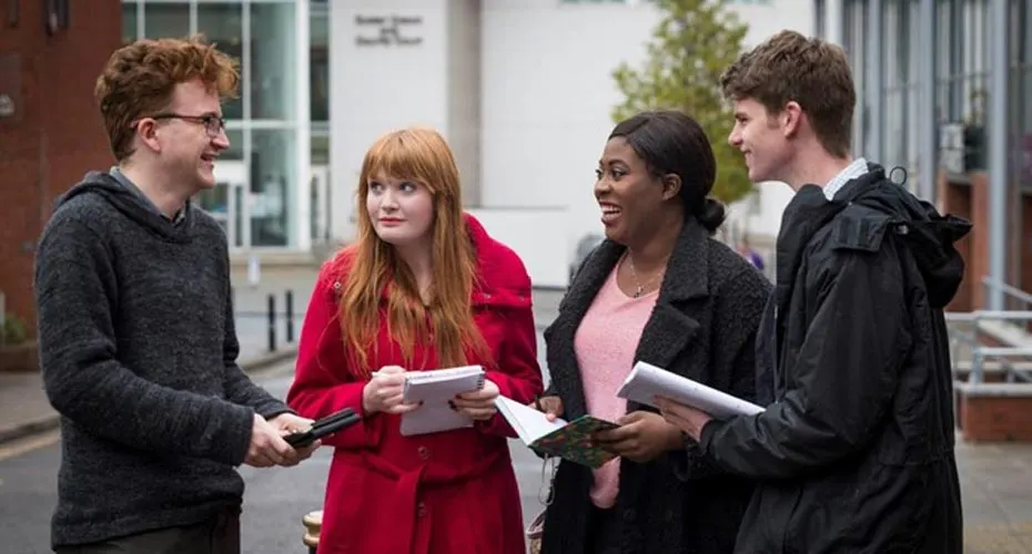 A group of students in discussion together outside